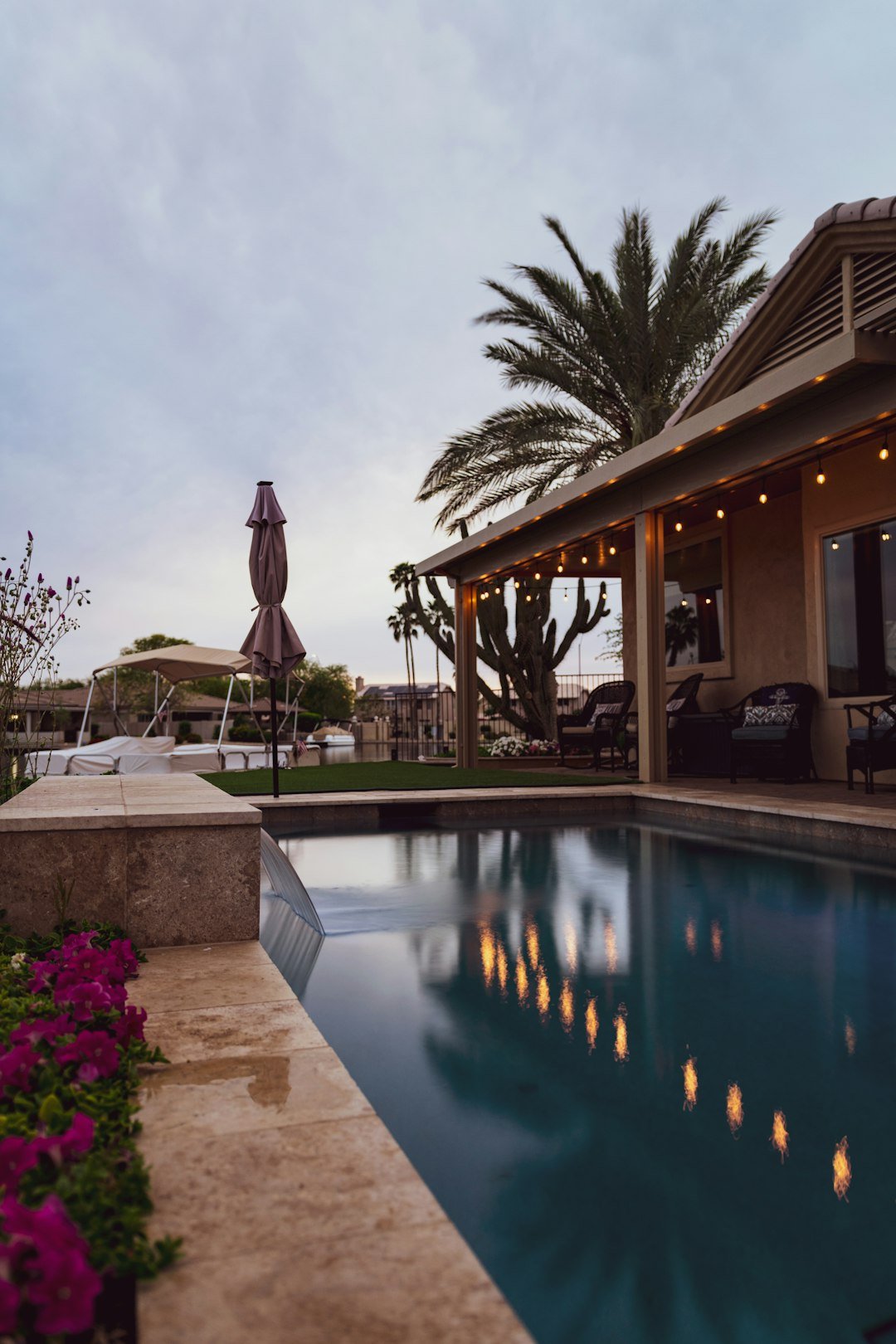 about-04 woman-in-brown-dress-standing-near-swimming-pool-during-daytime-0lrnxeyfk-m